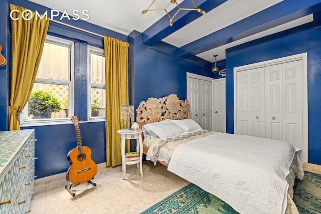 bedroom featuring multiple closets and baseboards