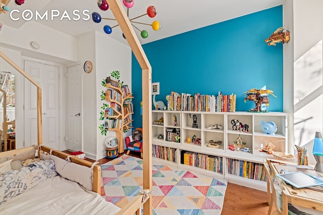 2166 Broadway Unit 4C, New York City, NY 10024 - bedroom featuring a chandelier and wood finished floors