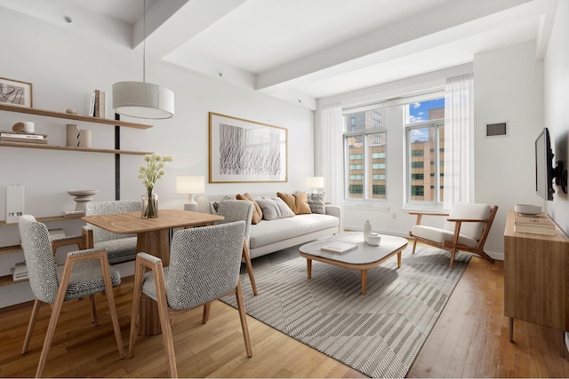 85 Adams St Unit 10B, New York City, NY 11201 - living room featuring light wood finished floors, beam ceiling, and baseboards