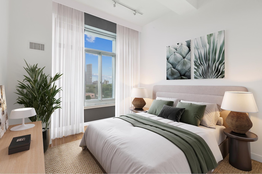 85 Adams St Unit 10B, New York City, NY 11201 - bedroom featuring rail lighting and wood finished floors