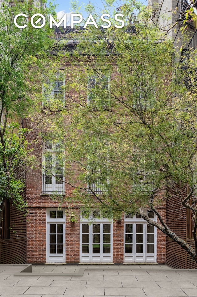 23 W 12th St, New York City, NY 10011 - rear view of property with a patio area and brick siding