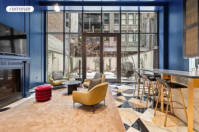 lobby with a wall of windows and a towering ceiling