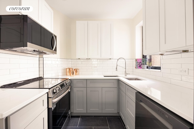 41 Prospect Park SW Unit 2B, New York City, NY 11215 - kitchen featuring stainless steel appliances, a sink, dark tile patterned floors, light countertops, and backsplash