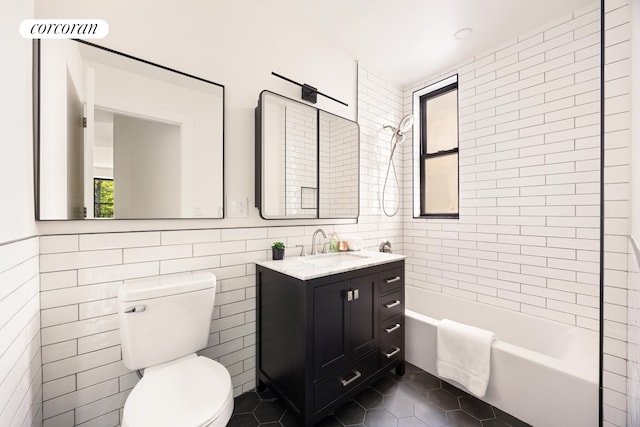 41 Prospect Park SW Unit 2B, New York City, NY 11215 - full bathroom featuring tile walls, shower / bathtub combination, toilet, vanity, and tile patterned floors