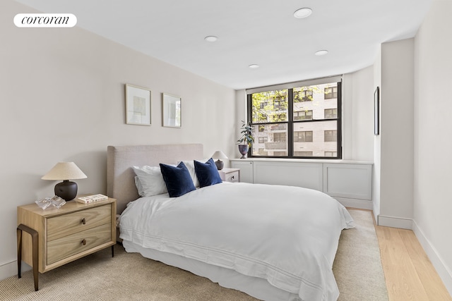 bedroom with light wood-style floors, recessed lighting, and baseboards