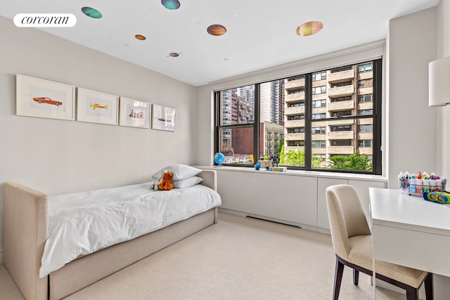 bedroom featuring light carpet
