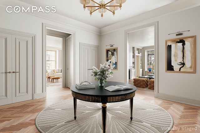 hallway featuring a chandelier and baseboards