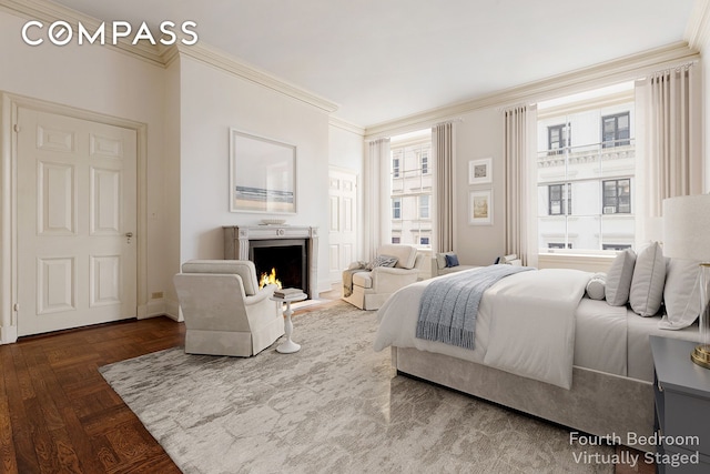 bedroom with crown molding and a lit fireplace