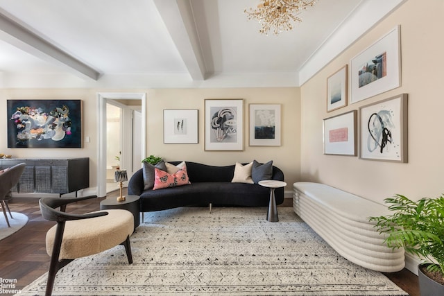 living room featuring beamed ceiling, baseboards, and a chandelier