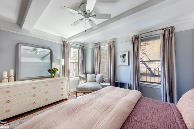 bedroom with beam ceiling and a ceiling fan