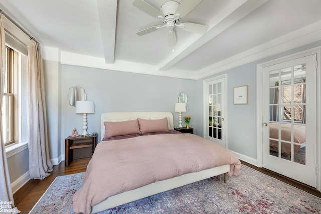 bedroom featuring beamed ceiling, dark wood-style flooring, baseboards, and ceiling fan