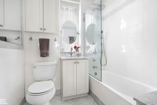full bath featuring tiled shower / bath combo, toilet, and vanity