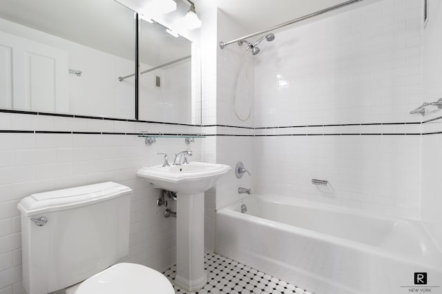 bathroom featuring toilet, shower / bath combination, tile walls, and tile patterned flooring