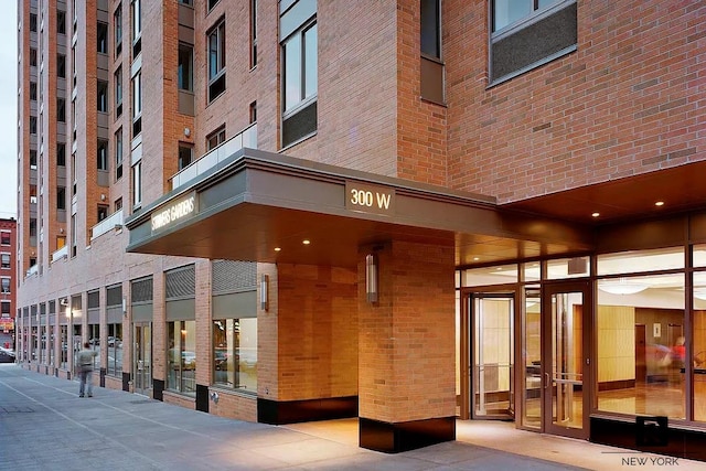 entrance to property featuring brick siding