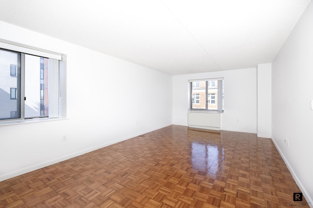 unfurnished room featuring baseboards