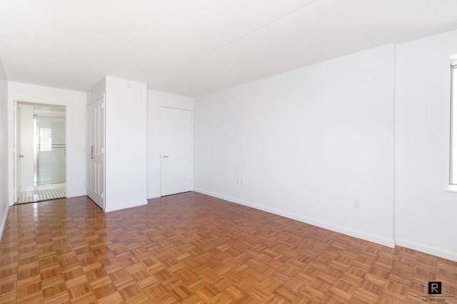 spare room featuring baseboards