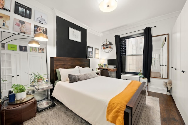 328 E 73rd St Unit 2C, New York City, NY 10021 - bedroom with dark wood-type flooring, crown molding, and baseboards
