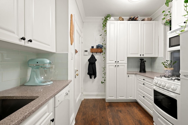 328 E 73rd St Unit 2C, New York City, NY 10021 - kitchen with white appliances, white cabinets, and decorative backsplash