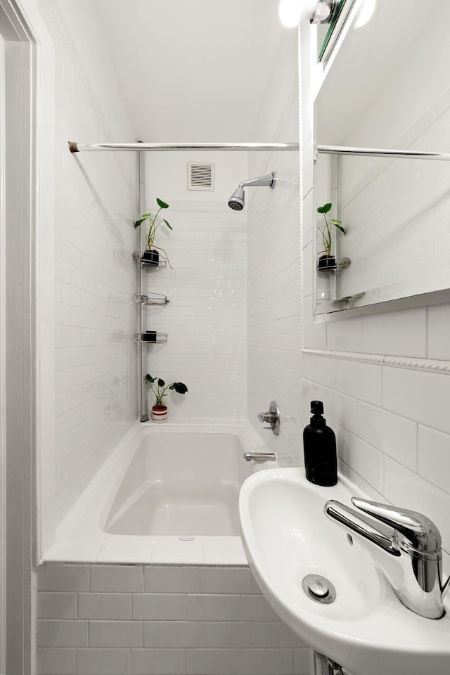 328 E 73rd St Unit 2C, New York City, NY 10021 - full bathroom featuring a sink and washtub / shower combination