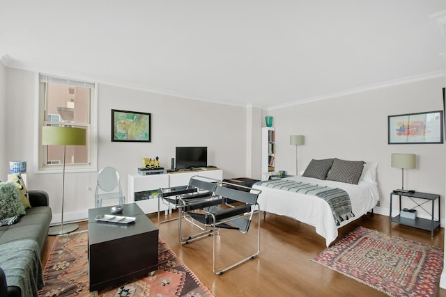 575 Main St Unit 1611, New York City, NY 10044 - bedroom with wood finished floors, crown molding, baseboards, and a desk