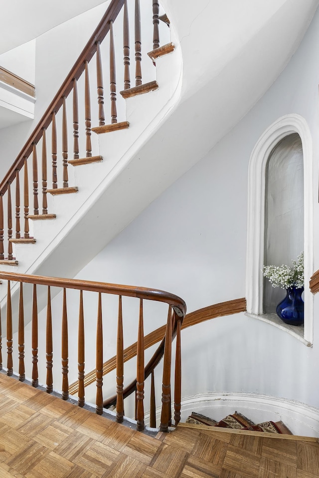 stairway featuring arched walkways