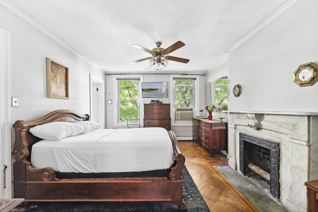 bedroom with crown molding, multiple windows, a fireplace, a ceiling fan, and a baseboard heating unit