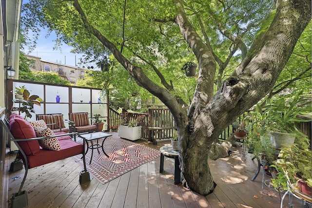 wooden terrace featuring outdoor lounge area