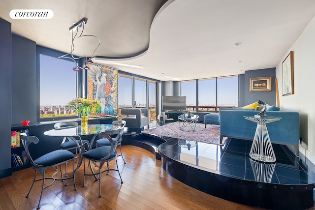 dining room featuring plenty of natural light, hardwood / wood-style flooring, and floor to ceiling windows