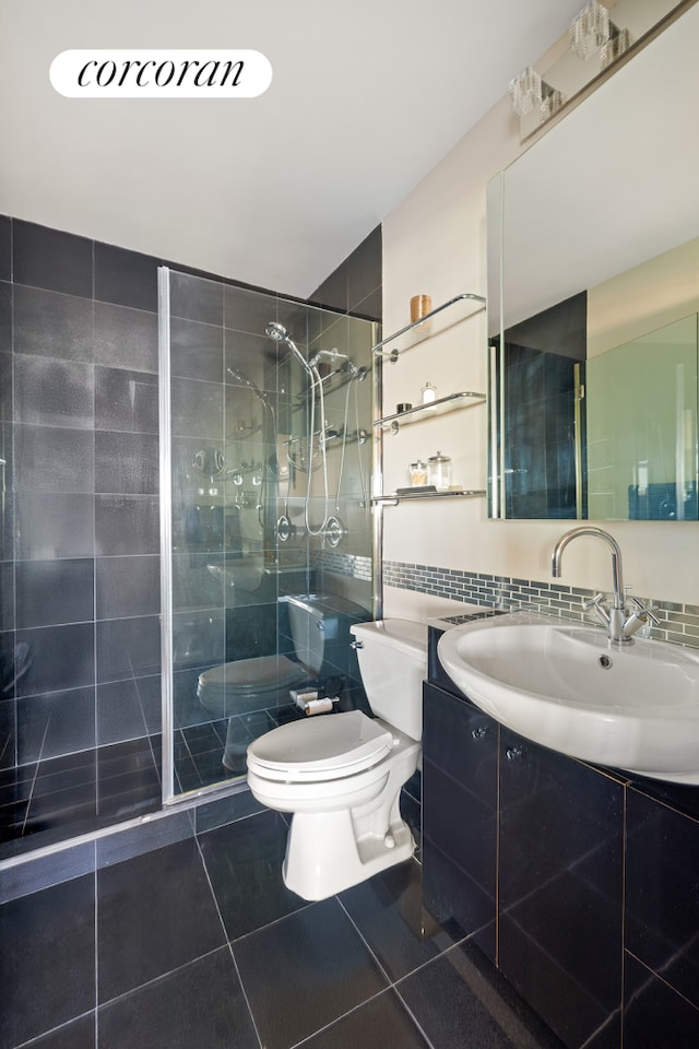 full bath with toilet, tile patterned flooring, a stall shower, tile walls, and vanity