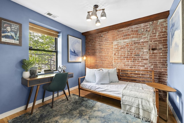 364 Manhattan Ave Unit 1-G, New York City, NY 11211 - bedroom featuring a desk, baseboards, wood finished floors, and brick wall