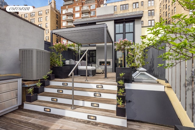 view of exterior entry with a deck and central air condition unit