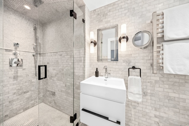 bathroom featuring tile walls, a shower stall, and vanity