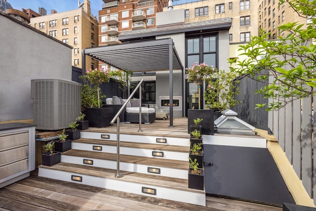 property entrance featuring a wooden deck and central AC unit
