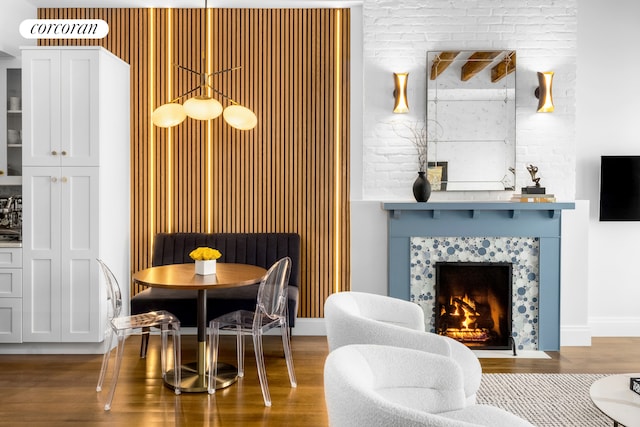 dining area with a fireplace and wood finished floors