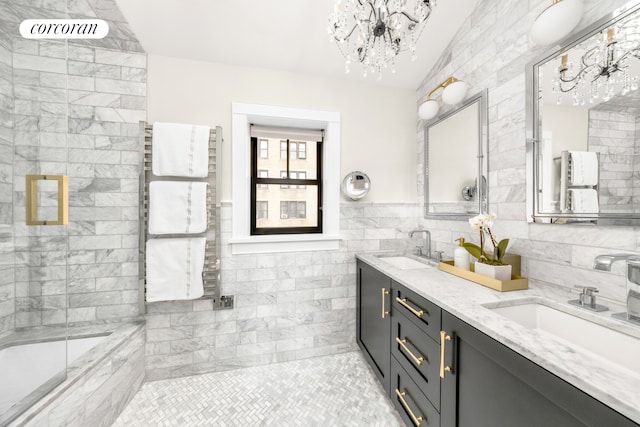full bathroom featuring radiator heating unit, tile walls, double vanity, tile patterned floors, and a chandelier