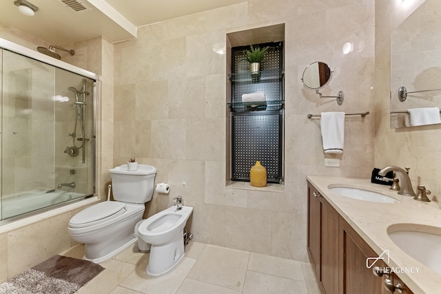 full bathroom featuring tile walls, a bidet, toilet, tiled shower / bath combo, and tile patterned flooring