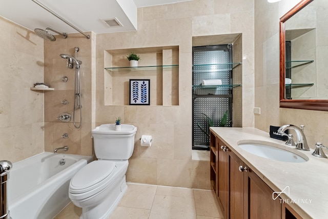 full bath with tile walls, toilet, vanity, bathing tub / shower combination, and tile patterned flooring