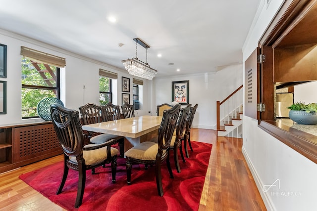 dining space with stairs, wood finished floors, recessed lighting, and ornamental molding