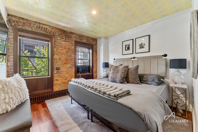 bedroom featuring wood finished floors, an ornate ceiling, and cooling unit