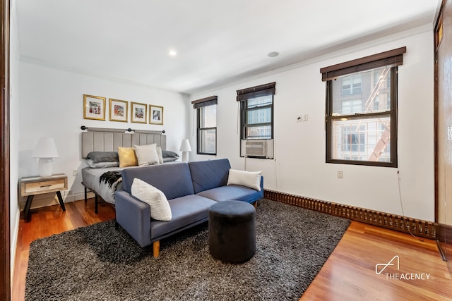 bedroom featuring multiple windows, wood finished floors, cooling unit, recessed lighting, and baseboards