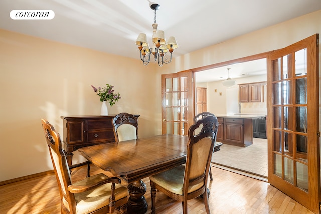 62 Rutland Rd, New York City, NY 11225 - dining area with a chandelier, light wood finished floors, and french doors