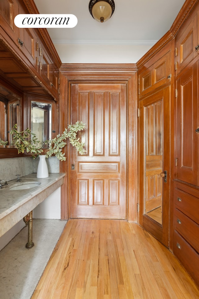 62 Rutland Rd, New York City, NY 11225 - entryway featuring light wood-type flooring, wood walls, and ornamental molding