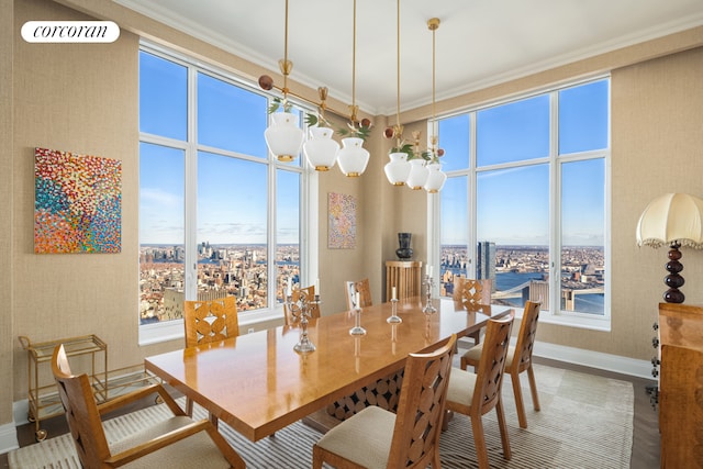 30 Park Pl Unit Ph77A, New York City, NY 10007 - dining space with baseboards, crown molding, a view of city, wood finished floors, and a chandelier