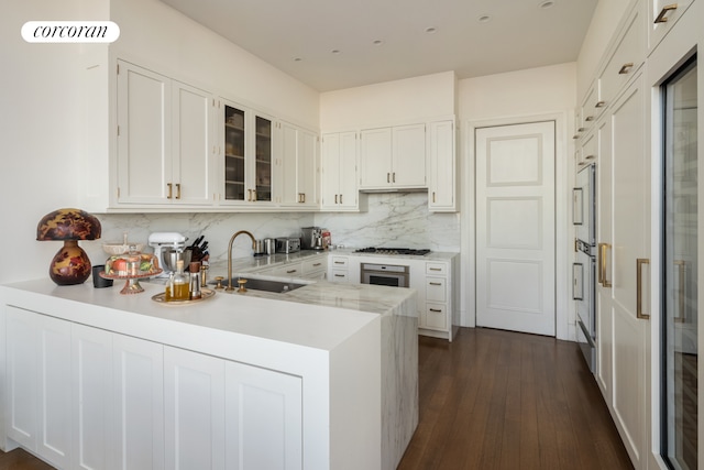 30 Park Pl Unit Ph77A, New York City, NY 10007 - kitchen with a sink, a peninsula, glass insert cabinets, backsplash, and white cabinetry