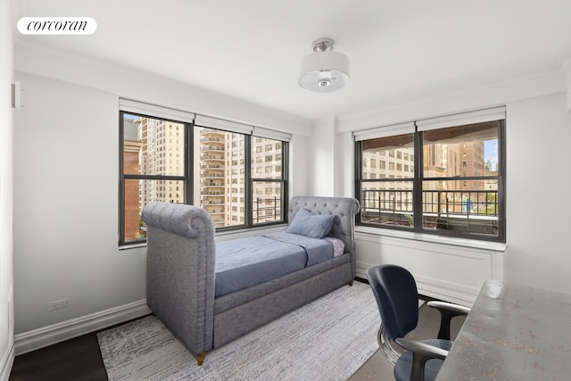 301 E 64th St Unit 7D, New York City, NY 10065 - office area with wood finished floors, healthy amount of natural light, baseboards, and crown molding