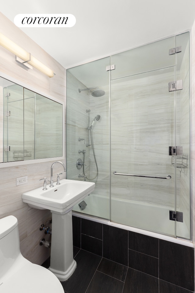 301 E 64th St Unit 7D, New York City, NY 10065 - full bath featuring toilet, tiled shower / bath, and tile walls