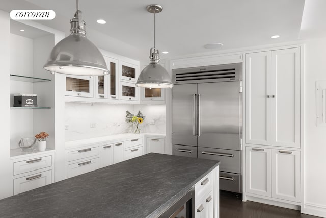 301 E 64th St Unit 7D, New York City, NY 10065 - kitchen featuring built in refrigerator, white cabinets, glass insert cabinets, recessed lighting, and decorative light fixtures