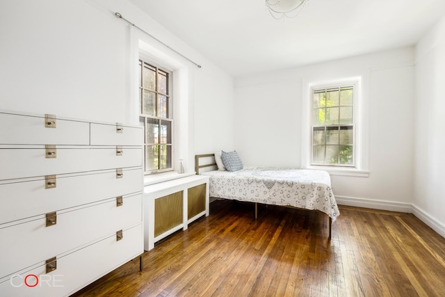 bedroom with baseboards and wood-type flooring