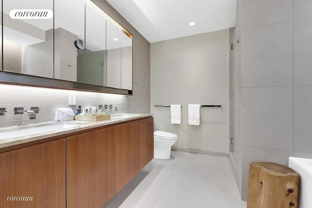 full bath featuring a shower stall, toilet, backsplash, tile patterned flooring, and double vanity