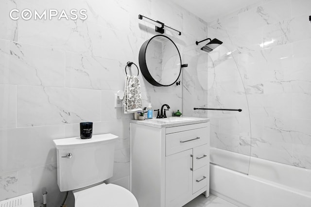 bathroom featuring tile walls, toilet, vanity, radiator, and tub / shower combination